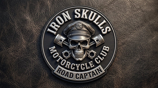 An angled close-up of a thick, custom molded 3D embroidered badge on leather, clearly showing the deep relief and polished texture of the 'IRON SKULLS' and 'ROAD CAPTAIN' elements.