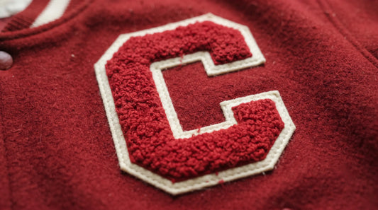 Red and white varsity style chenille patch with fluffy raised pile