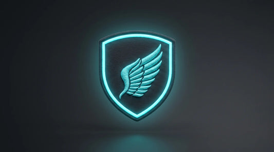 A modern high-end studio photograph of a single shield-shaped embroidered badge patch presented face-on against a clean dark charcoal gradient background. The patch utilizes advanced 3D puff embroidery and specialized glow-in-the-dark threads to showcase an eagle wing icon. Balanced studio lighting illuminates the overall scene, allowing the raised embroidered elements to emit a striking, luminous cyan glow that showcases both the 3D relief and the luminescent feature clearly.
