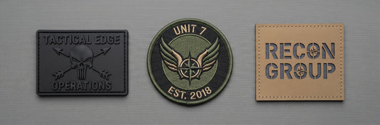 A clean, brightly lit overhead studio shot of three different material tactical patches arranged in a neat horizontal line on a smooth, matte grey tactical canvas. The patches are viewed head-on and appear identical in size and alignment.