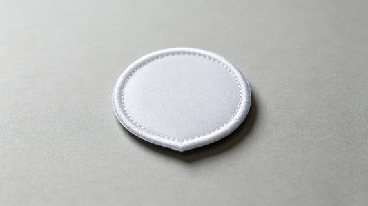 Detailed view of uniform heat seal adhesive layer on iron-on custom patch rear side