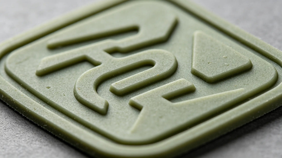 Macro close-up showing smooth soft rubber texture and recessed filled color of PVC patch