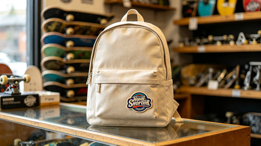 Skate team canvas backpack placed inside local skate shop, 3D foam raised embroidered patch sewn on front pocket