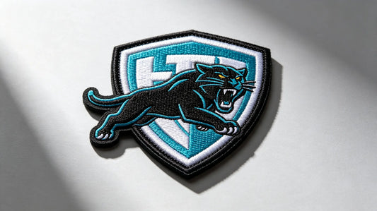 Single sports mascot 3D raised foam embroidered patch, clean bright studio product shot, pronounced layered embroidery relief.