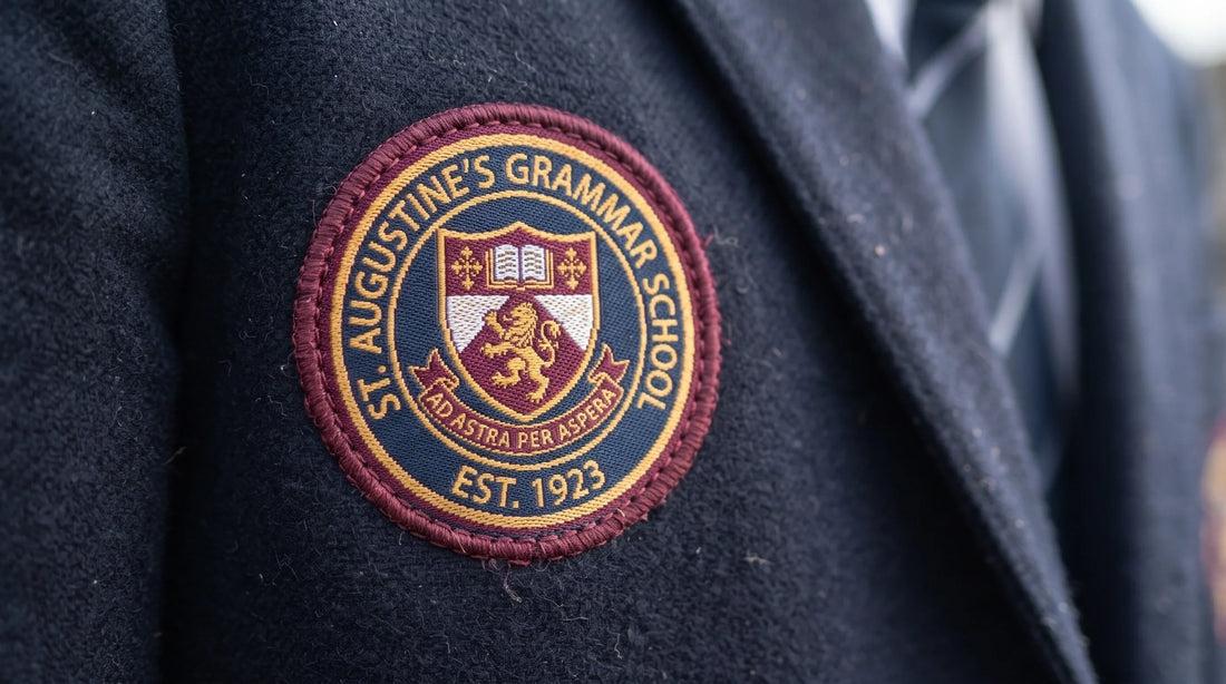 Detailed woven custom school crest badge stitched onto the left chest of a student school uniform shirt