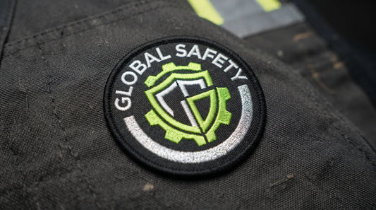 Macro detail of a high-visibility embroidered safety badge.