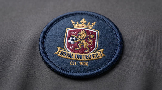 Detailed close-up of the merrowed border and fine stitching of a single professional football patch.