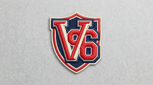 A complete view of a single, custom-designed 3D puff embroidered badge, inspired by image_0.png. The patch, shaped like a shield, displays a stylized "V" and "86" combination in raised, dimensional red and cream thread on a navy felt background, embodying classic collegiate style.