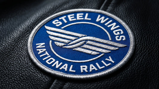 A circular royal blue motorcycle club patch on black leather featuring silver streamlined parallel lines representing speed with text "Steel Wings National Rally".